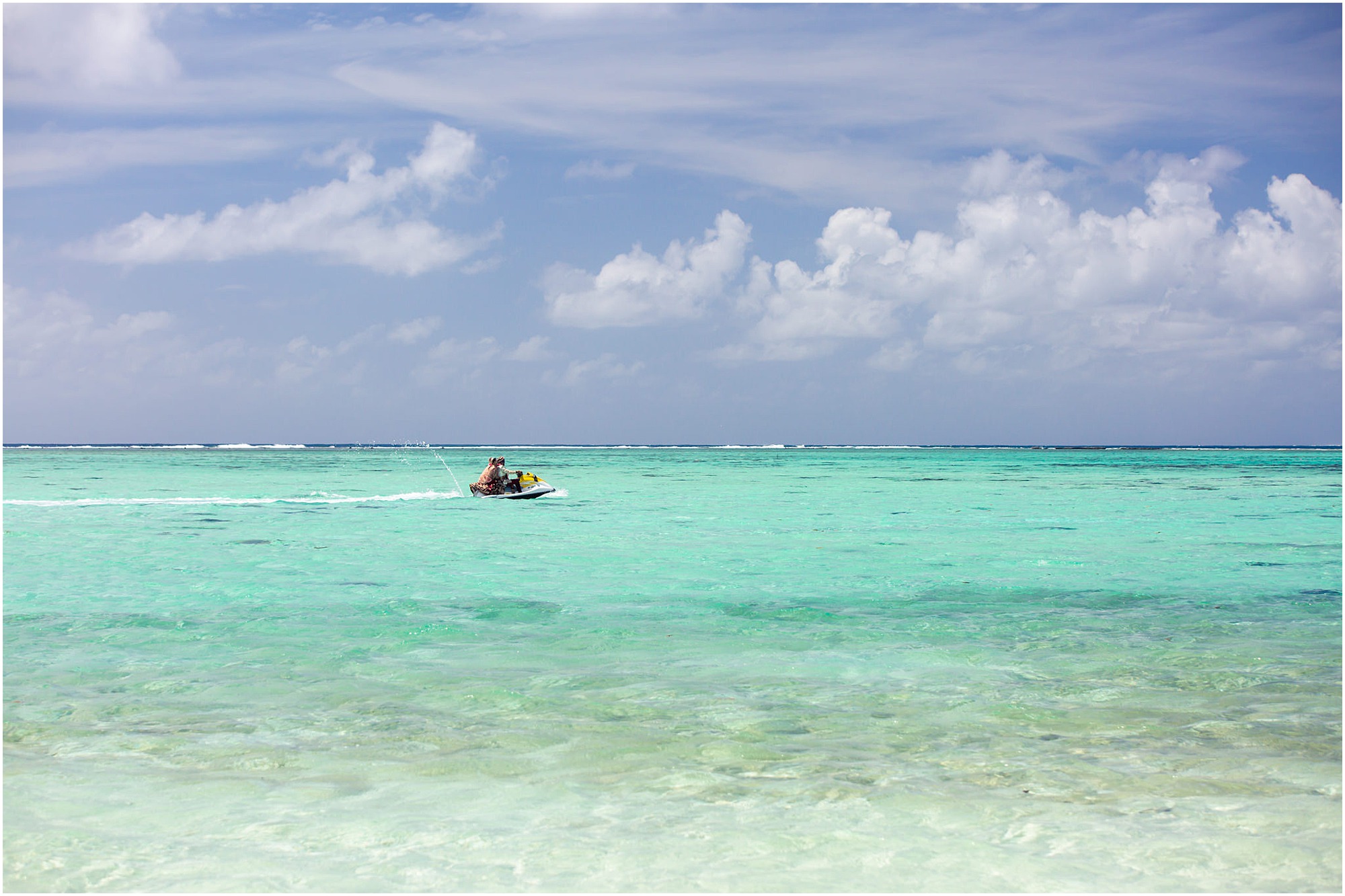 bora bora motu tapu bride and groom riding away in jetski